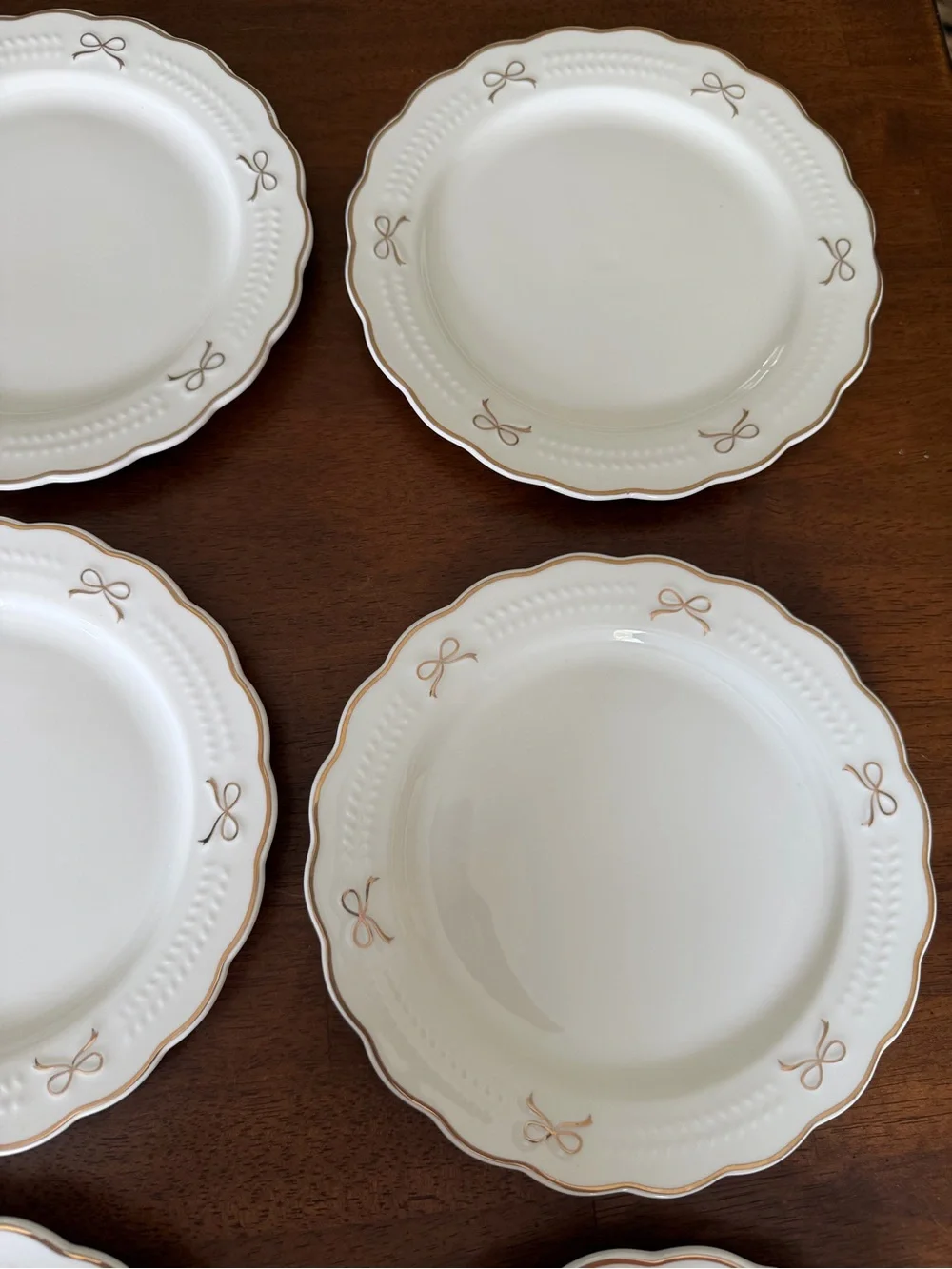 Set of White Scalloped Dinner Plates with Gold Bow Details